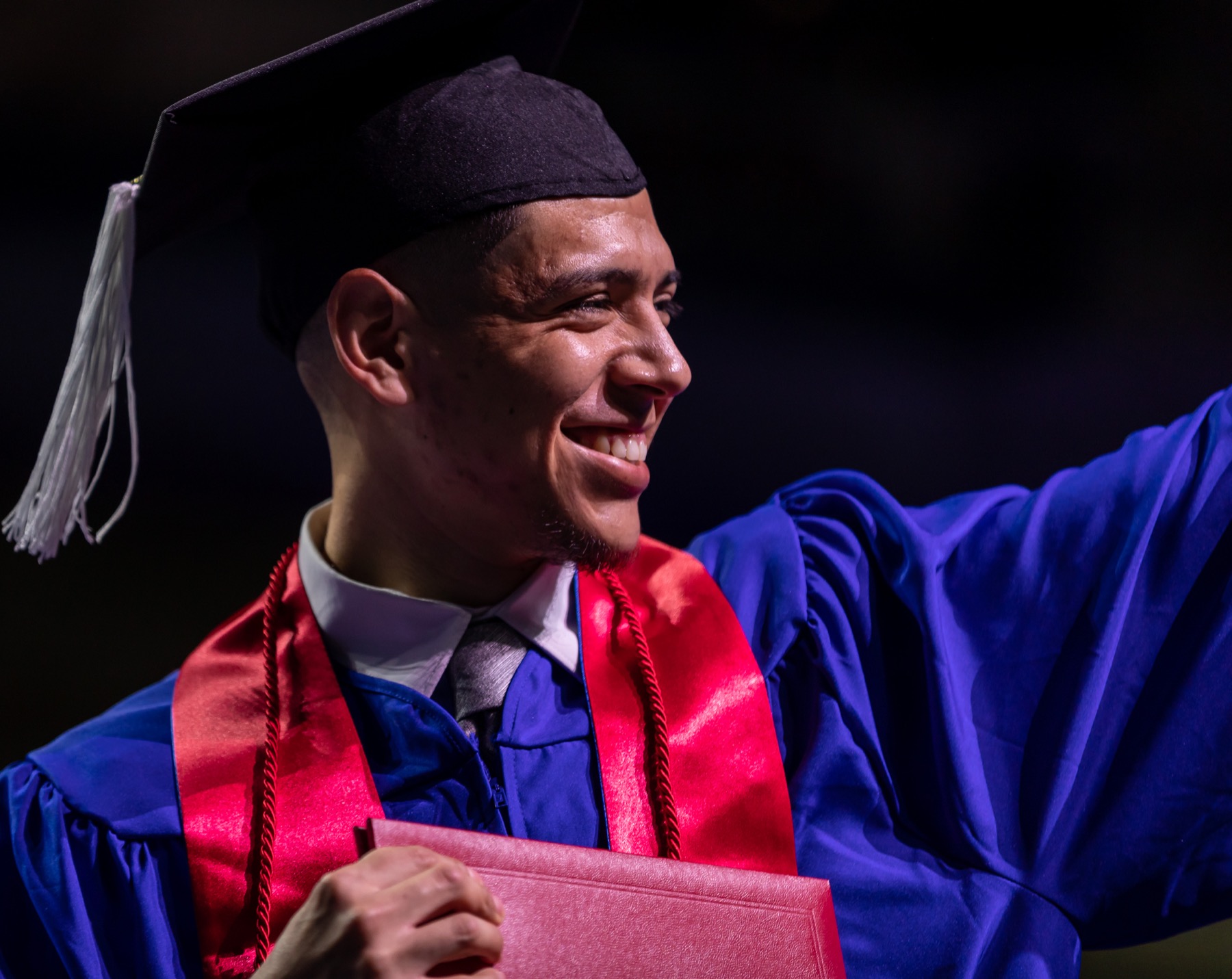 A graduate waved to his family after receiving his diploma.
